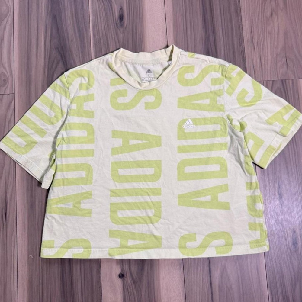 Adidas white and green cropped tee in size large featuring repeating "ADIDAS"